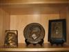 Group of bas-relief plaques and bookends depicting Theodore Roosevelt and his home.